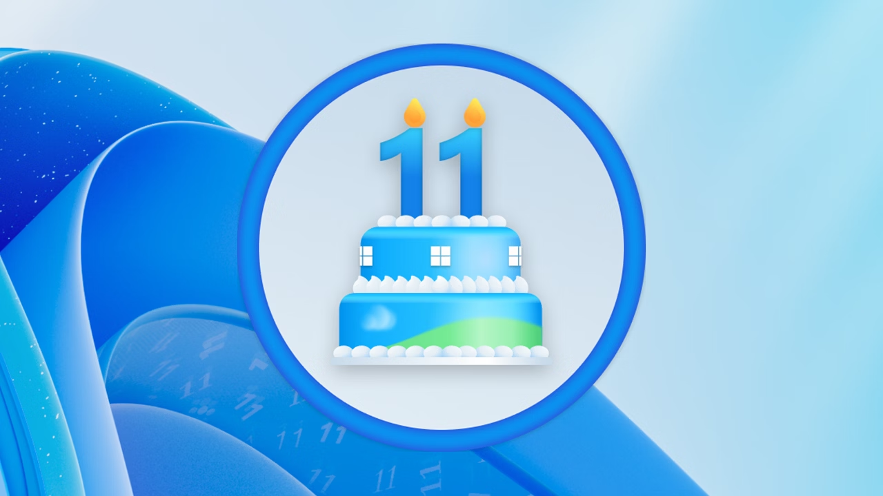 Zweistufige Torte innerhalb eines Kreises vor einem Windows 11 Bloom-Hintergrund. Zwei Kerzen auf der Torte bilden die Zahl 11, drei Windows-Logos auf der oberen Etage, Himmelblau und grüne Grasillustration auf der unteren Etage. Lesen Sie den Jubiläumsartikel.